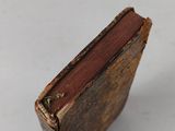 an old book sitting on top of a white table