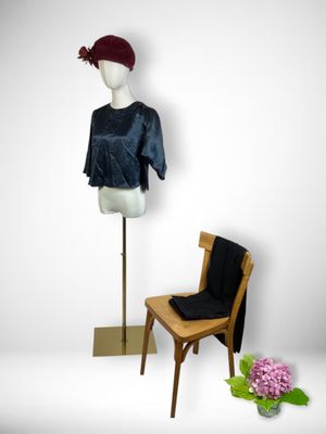 a mannequin and a chair in front of a mannequin