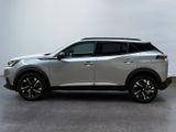 a silver nissan suv parked in a room with a white wall