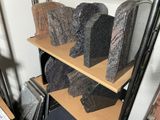 a lot of granite blocks on a shelf in a room