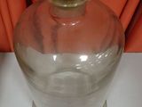 a glass jar with a cork top sitting on a table