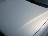 a white car that is parked on the side of the street