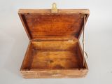 a small wooden box that is open on a white surface