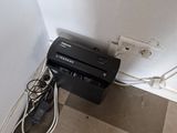 an image of a tv and a printer in the corner of a room