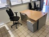 a desk with a chair and a computer on it