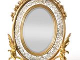 a mirror that is sitting on a stand on a white surface