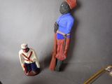 two figurines of a man and a woman standing next to each other