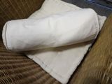 a blanket on a couch with a pillow on top of it
