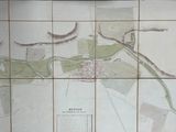 a map on the wall of a bathroom with a toilet in it