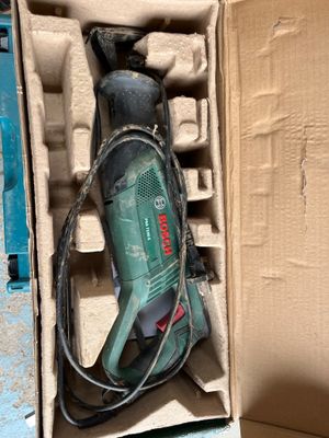 a box with a drill in it on the floor