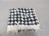 an image of a black and white blanket on a couch
