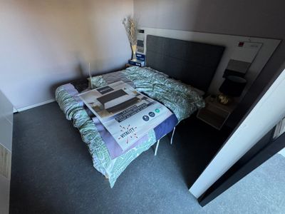 a bed that has a newspaper on it in a room