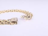 a close up of a gold chain bracelet with a padlock on it