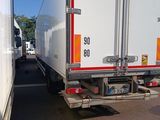 two trucks that are parked in a parking lot