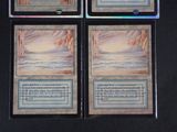 three decks of a card game with a picture of a mountain in the background