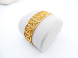 a close up of a gold ring on a white surface