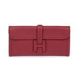 a red leather wallet with a metal clasp on the front