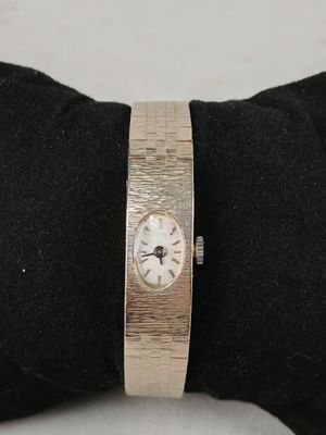 someone is wearing a watch on their wrist on a black glove