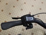a close up of a bicycle handlebar with a clock on it