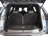 the back of a car with its trunk open and the seats folded down