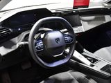 a steering wheel and dashboard of a car on display at a car show