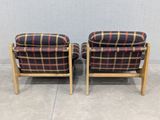 pair of mid century danish lounge chairs with plaid upholstered cushions