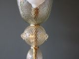 a glass vase with a white ball inside of it