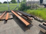 a pile of wood sitting on the ground next to a fence