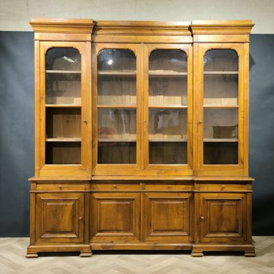 an old wooden china cabinet with glass doors and shelves