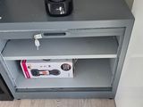 a small cabinet with a coffee maker on top of it