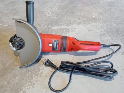 an image of a small electric grinder on the ground