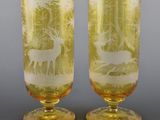 pair of etched glass goblets with deer and trees on them