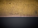 an image of a close up of a piece of metal with writing on it