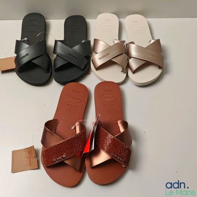 three pairs of women ' s sandals are lined up on a table