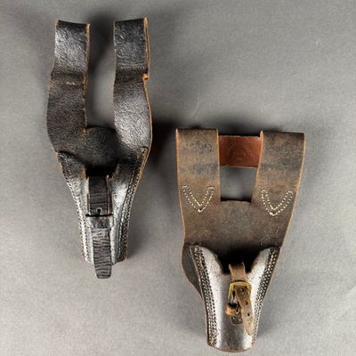 two pieces of leather are attached to the back of a pair of shoes