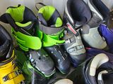 several pairs of ski boots are lined up on the floor