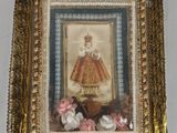 a picture of a woman in a dress hanging on a wall