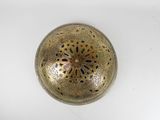 an antique brass plate with a flower design on it