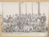 a black and white photo of a group of men posing for a picture