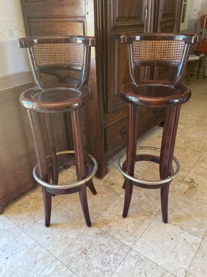 two wooden stools sitting next to each other in a room