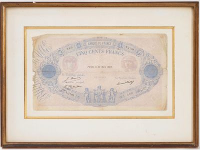 un ancien billet de banque sur lequel figure, en arrière-plan, l'image d'une ville