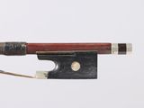 violin bow made of wood and metal with a red handle