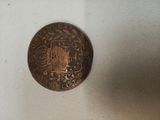 a small coin sitting on top of a white surface