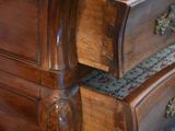 a wooden desk with two drawers on top of it
