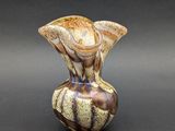 a vase that has a brown and white design on it