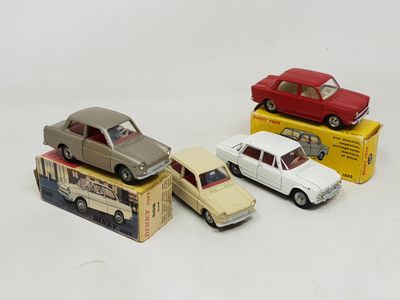 three toy cars are sitting on top of a box on a white surface