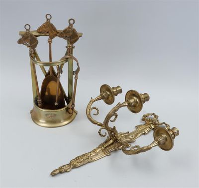 two antique brass objects including a clock, a candle holder, and a pair of scissors