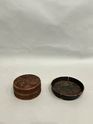 two small wooden boxes sitting next to each other on a white surface