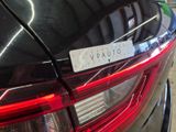 the rear end of a black car with a sticker on it