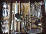many silverware in a wooden box with spoons and knives